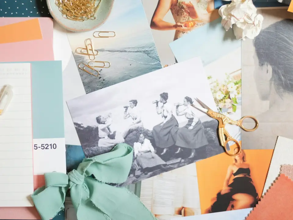 A mood board of photographs, swatches, ribbon and scissors